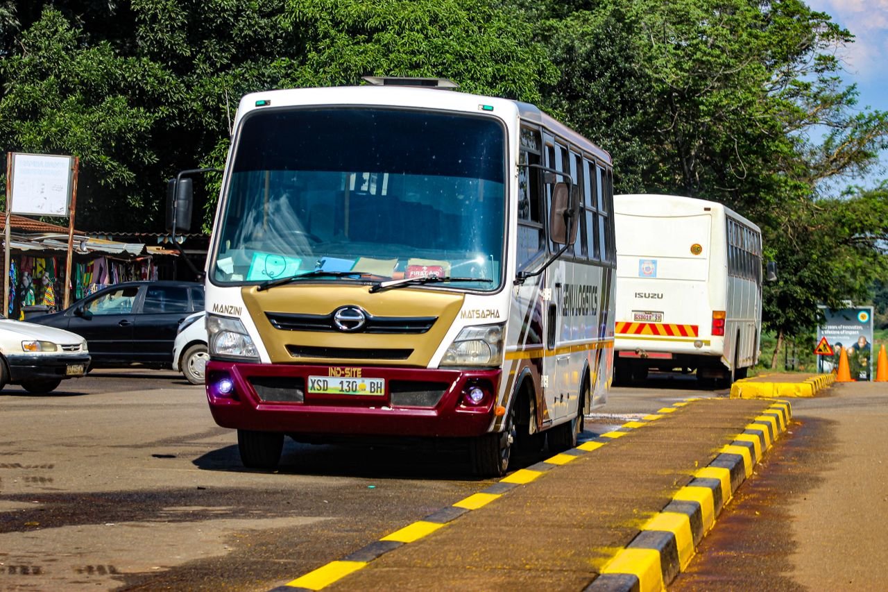 A vibrant minibus taxi captured on a bustling street in Matsapha, Eswatini, showcasing local public transportation.